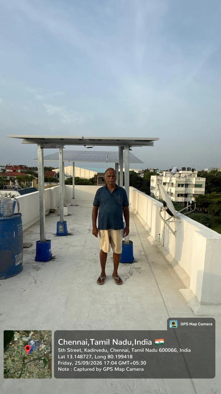 Elevated rooftop solar structure with happy homeowner at Kadirvedu, Chennai — residential solar power installation by Gensolar Energy Pvt Ltd, photographed 25 September 2026.